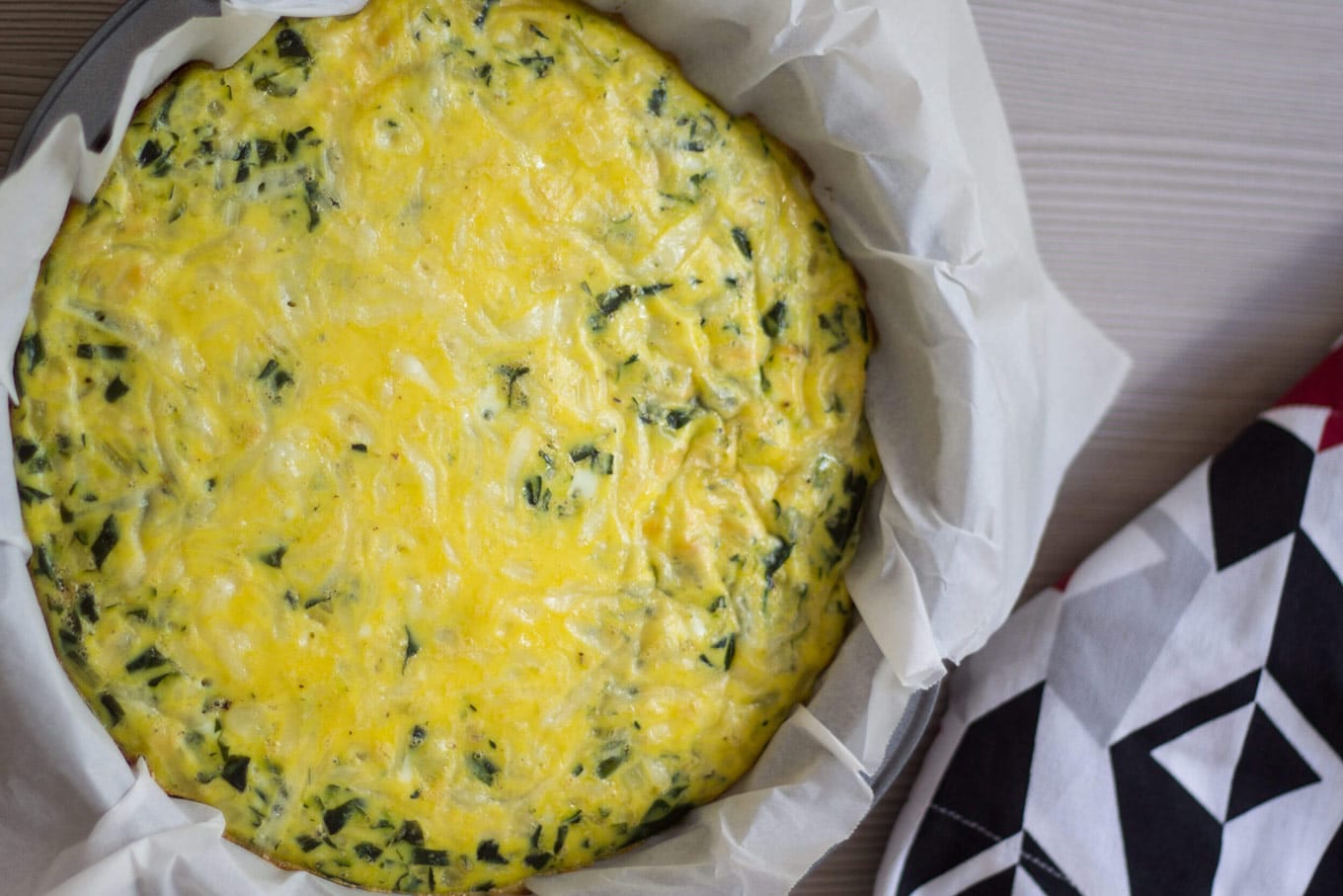 baked spinach and zucchini crustless quiche in the baking tin.