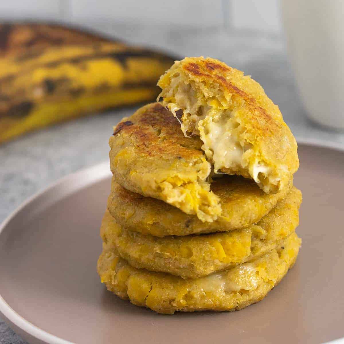 Cooked stuffed plantain arepas with cheese